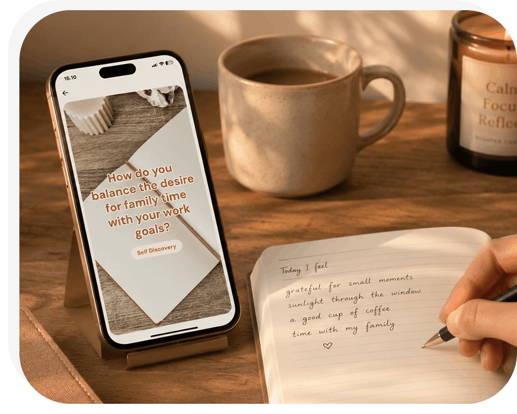 Phone with a personalized journaling prompt beside a paper journal